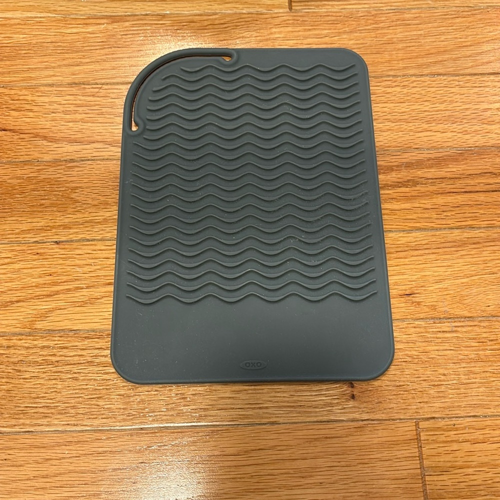 Mat for heat tools and it can be secured for travel
